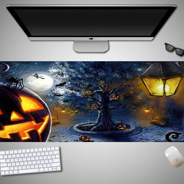 Oversized Halloween-themed computer mouse pad with non-slip rubber cloth base on a desk