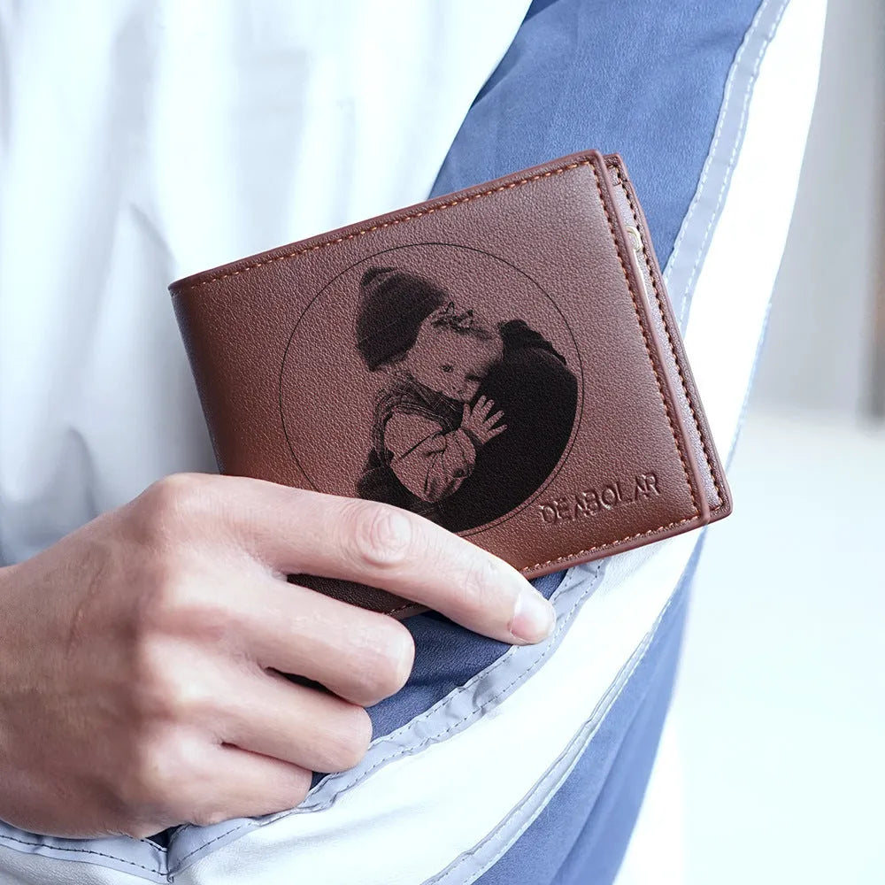 Men's brown leather wallet with a silver zipper closure laid flat.