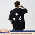 Men's loose fit black cotton t-shirt with a letter print on the front, short sleeves, and a round neck.
