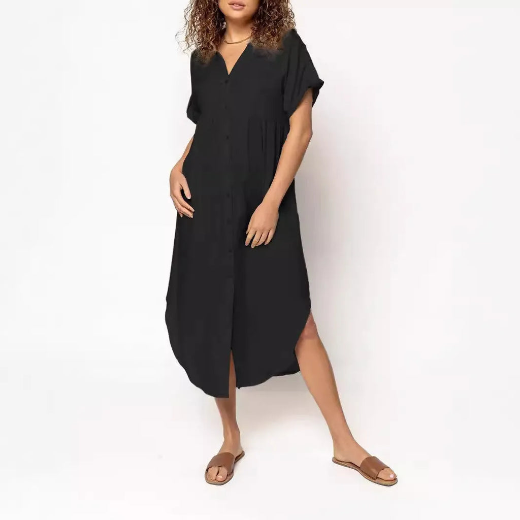 A loose-fitting, solid colour mid-length casual dress with a button-down front and regular sleeves.
