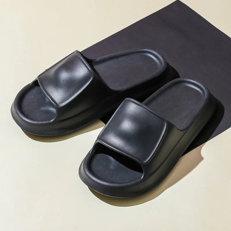 Thick-soled EVA flip-flop slippers in multiple colours on a bathroom floor, showing non-slip sole texture.