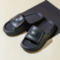 Thick-soled EVA flip-flop slippers in multiple colours on a bathroom floor, showing non-slip sole texture.