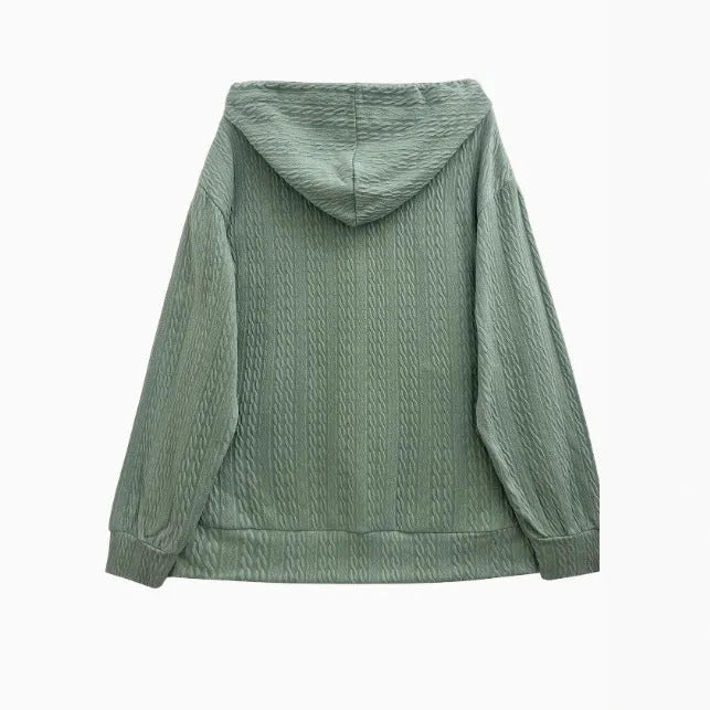 Green women's loose-fit hooded zip-up jacket on a hanger