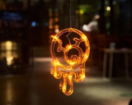 Set of seven battery-powered Halloween LED hanging lights with ghost, spider, and pumpkin designs for window decoration.