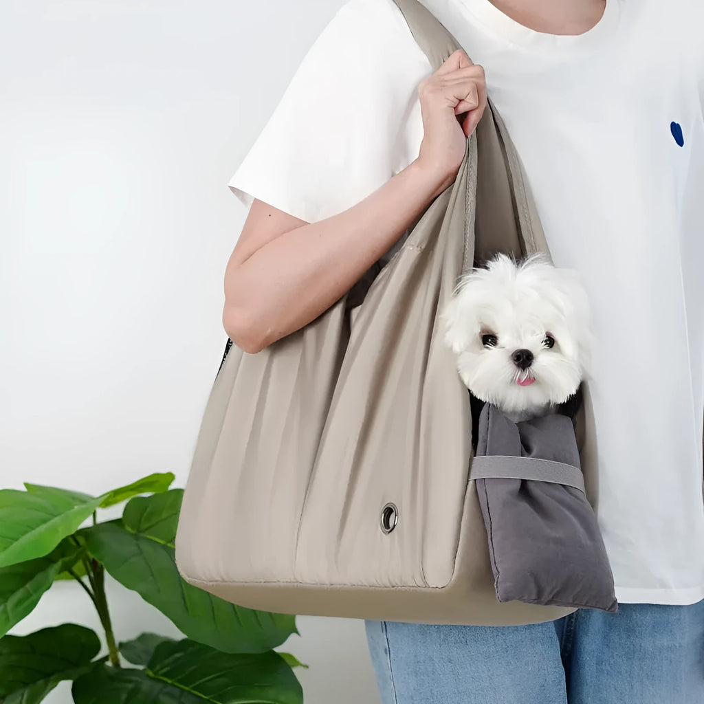 Apricot coloured cloth pet handbag for outdoor summer use.