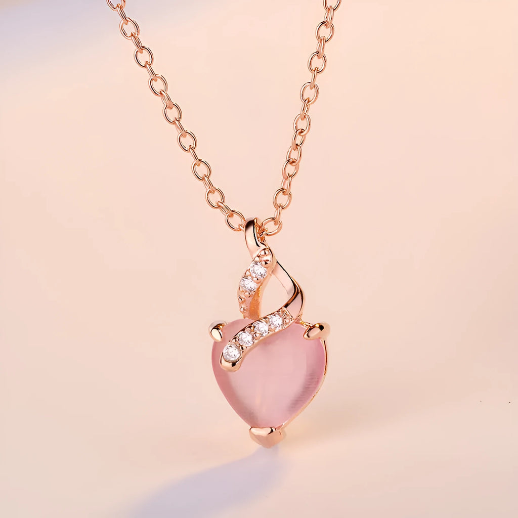 Women's rose gold heart pendant necklace with pink crystal on cross chain