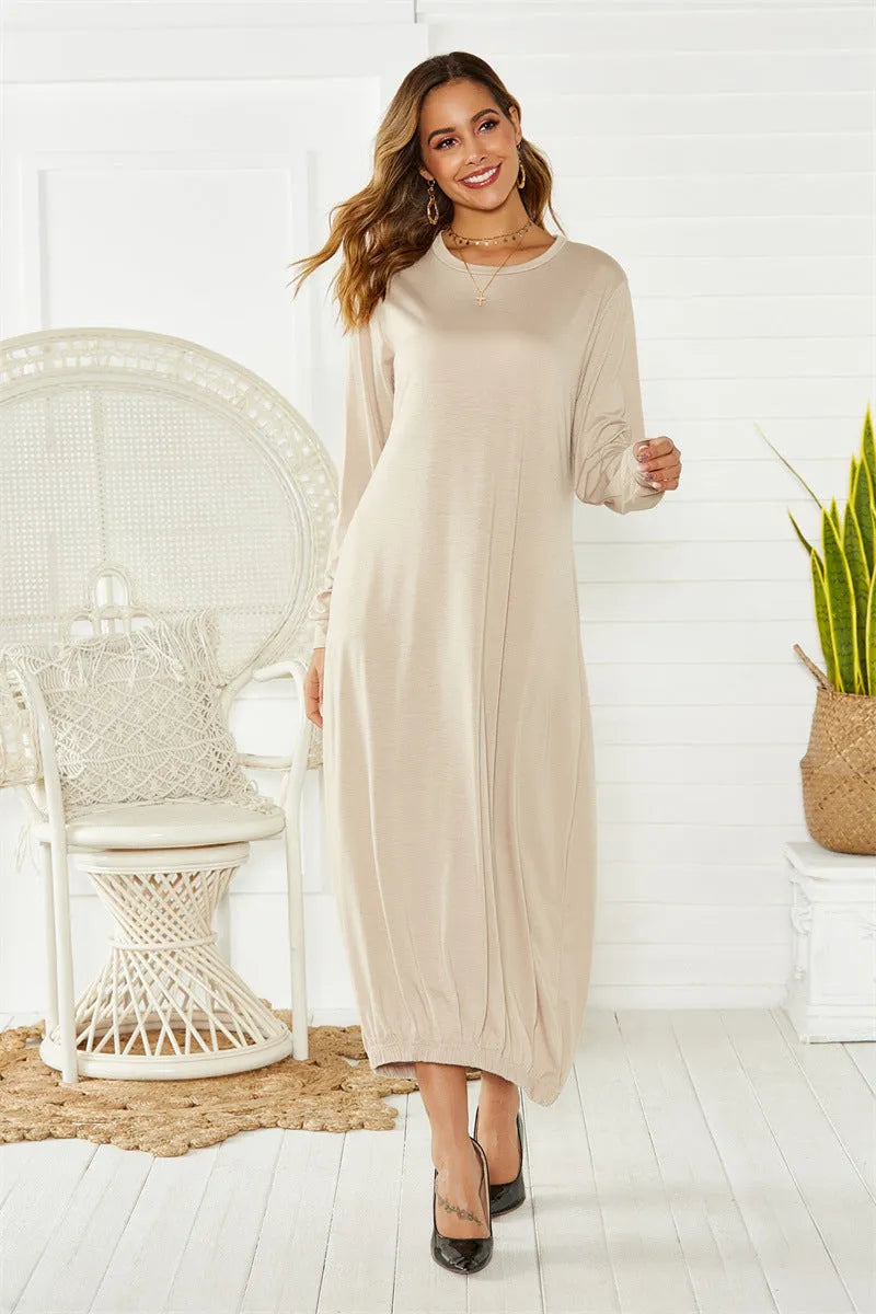 Loose black lantern dress with a lace-up crew neck, showcasing a relaxed silhouette.