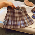 Girls' red and black plaid pleated A-line skirt on a hanger, showing cotton lining.