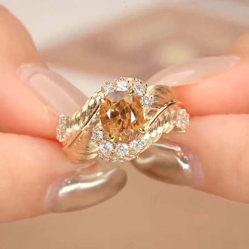 Gold coloured copper feather ring with embossed design and yellow zircon stone.