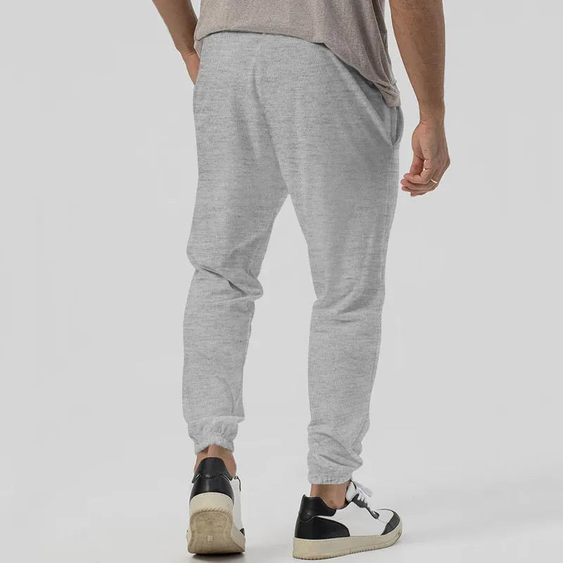 Men's grey cotton blend track sweatpants with straight-leg design and mid waist