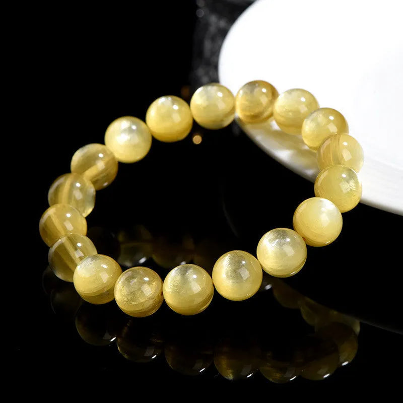Yellow Lepidolite mica stone bead bracelet with round geometric design on wrist