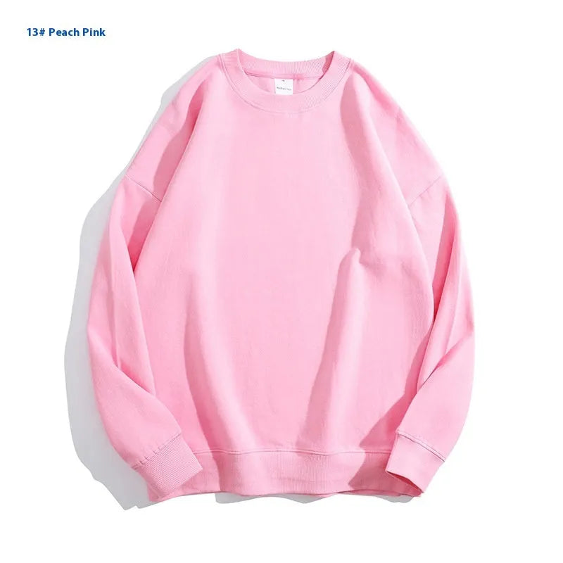 A loose round neck off shoulder pullover sweater in a solid colour, with long sleeves.