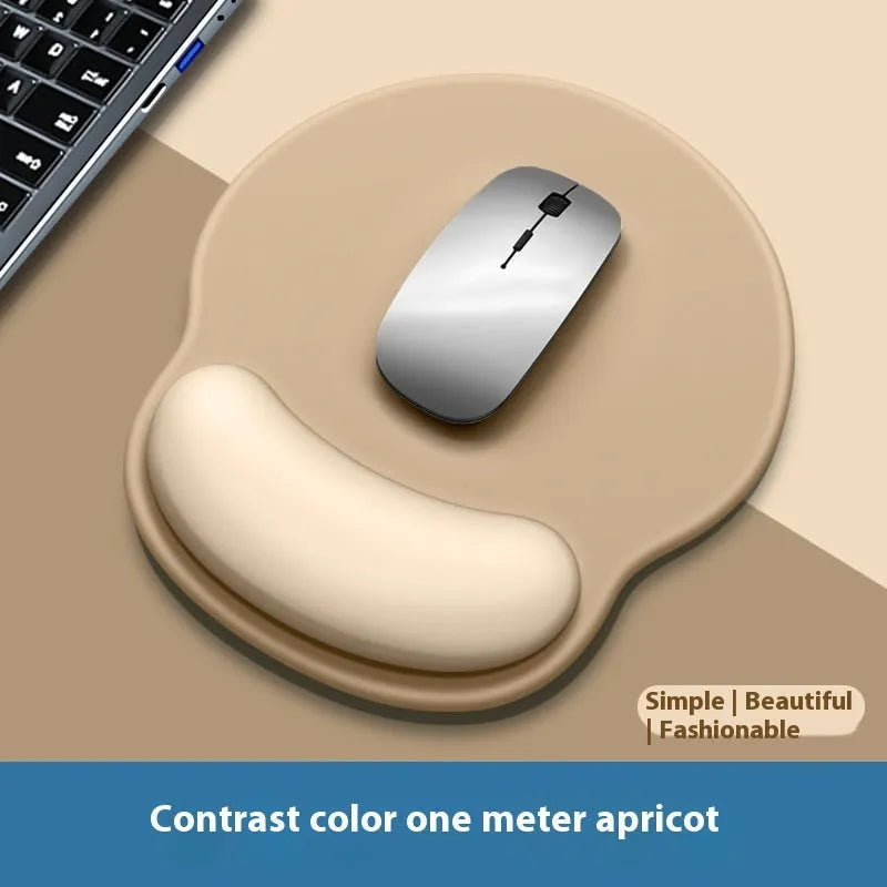 Silicone mouse mat with attached gel wrist support in a gradient blue colour on a desk.