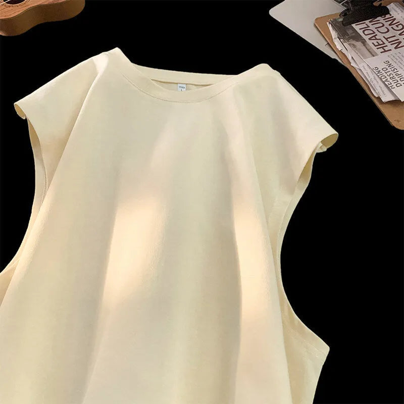 Men's solid colour loose fit cotton tank top on a hanger, showing straight hem and sleeveless design.