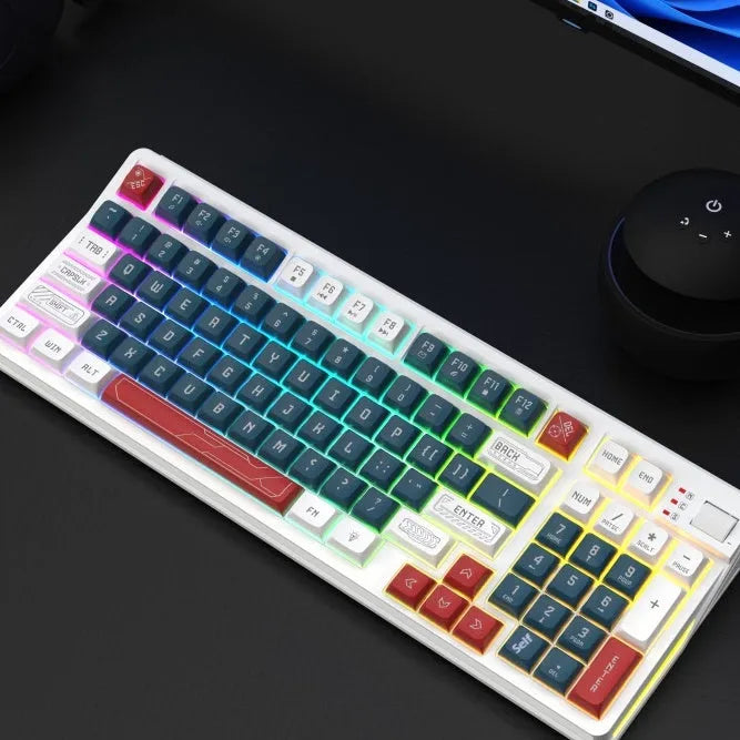 Three-colour luminous mechanical-feel USB keyboard in desktop setup showing backlighting