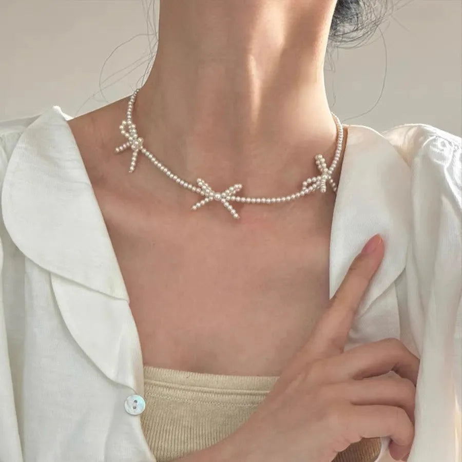 Sweet bow pearl necklace with geometric charm on adjustable 31-40cm chain