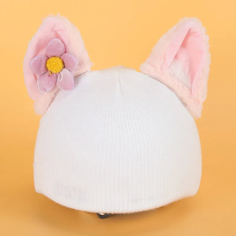 A plush fabric cartoon character helmet hat cover with attached ears on a white background.