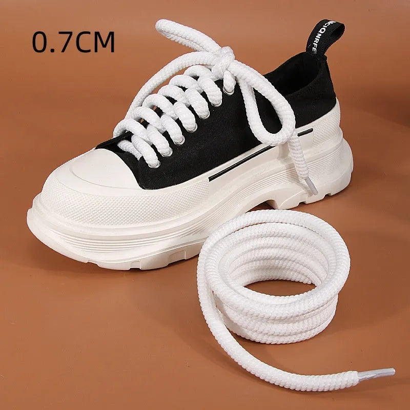 Pair of round woven shoelaces in white next to a ruler showing 10mm diameter and length scale.